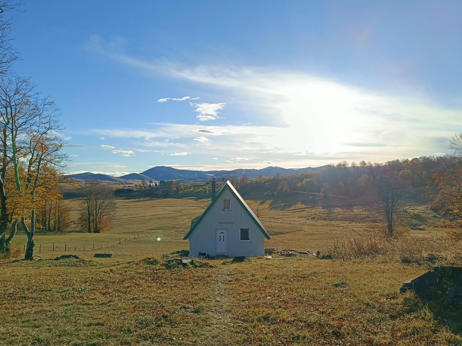 Family house with a gable roof in an autumn meadow in Durmitor